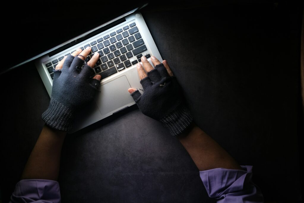 Cyber Criminal typing on a laptop
